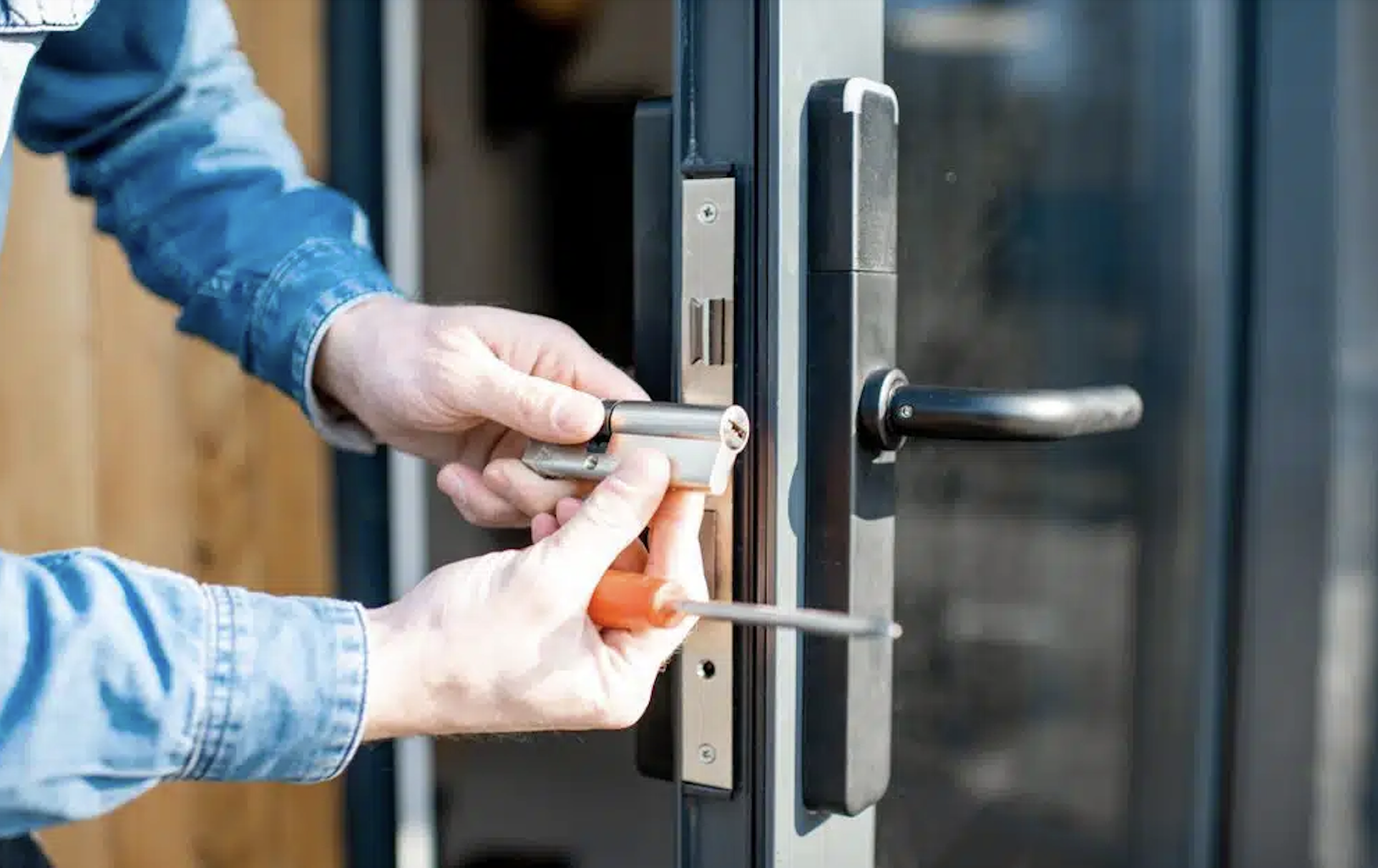 Locksmith installing a new euro-cylinder lock on a glass front door in Northern Rivers NSW